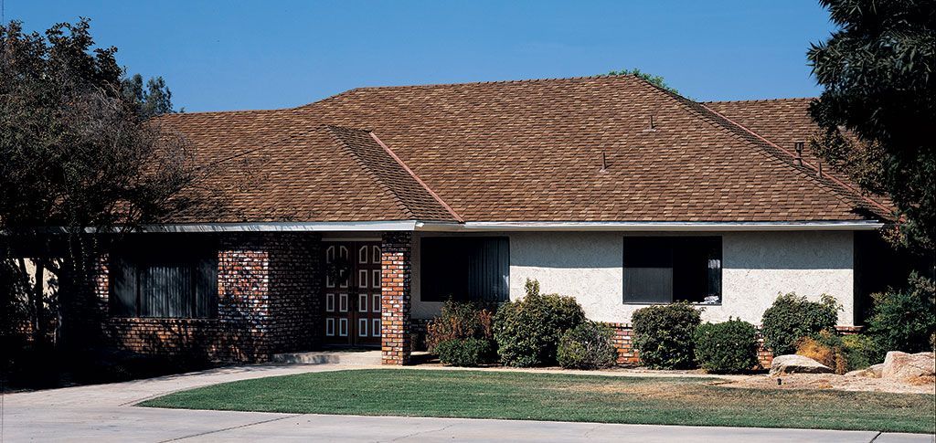 Coordinated roof, brick exterior and windows on a ranch-style home